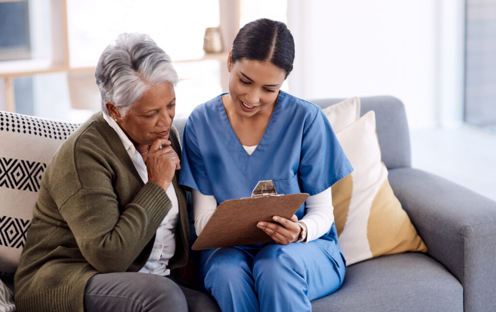 Nurse Talking Old Woman Patient about Healthcare Documents