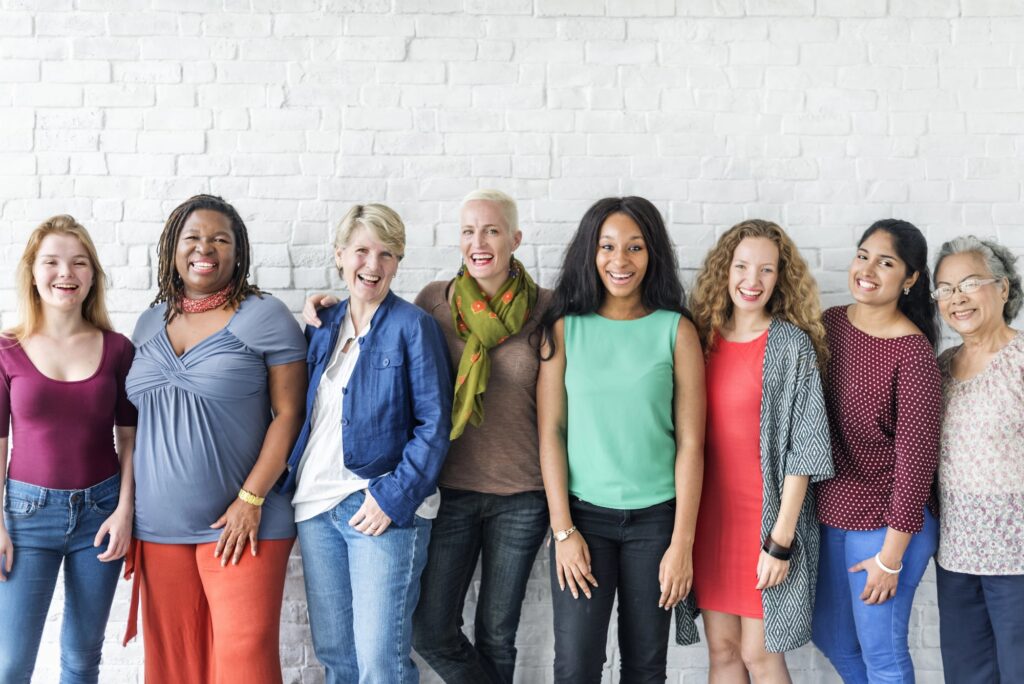 group photo of diverse women smiling at the camera